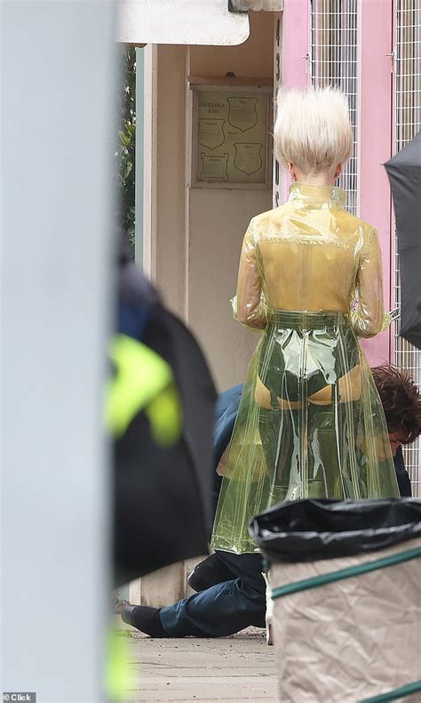 Maisie Williams goes topless beneath clear PVC .